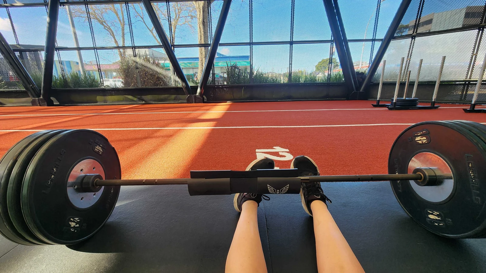 Amanda&rsquo;s view down a loaded barbell on the gym floor