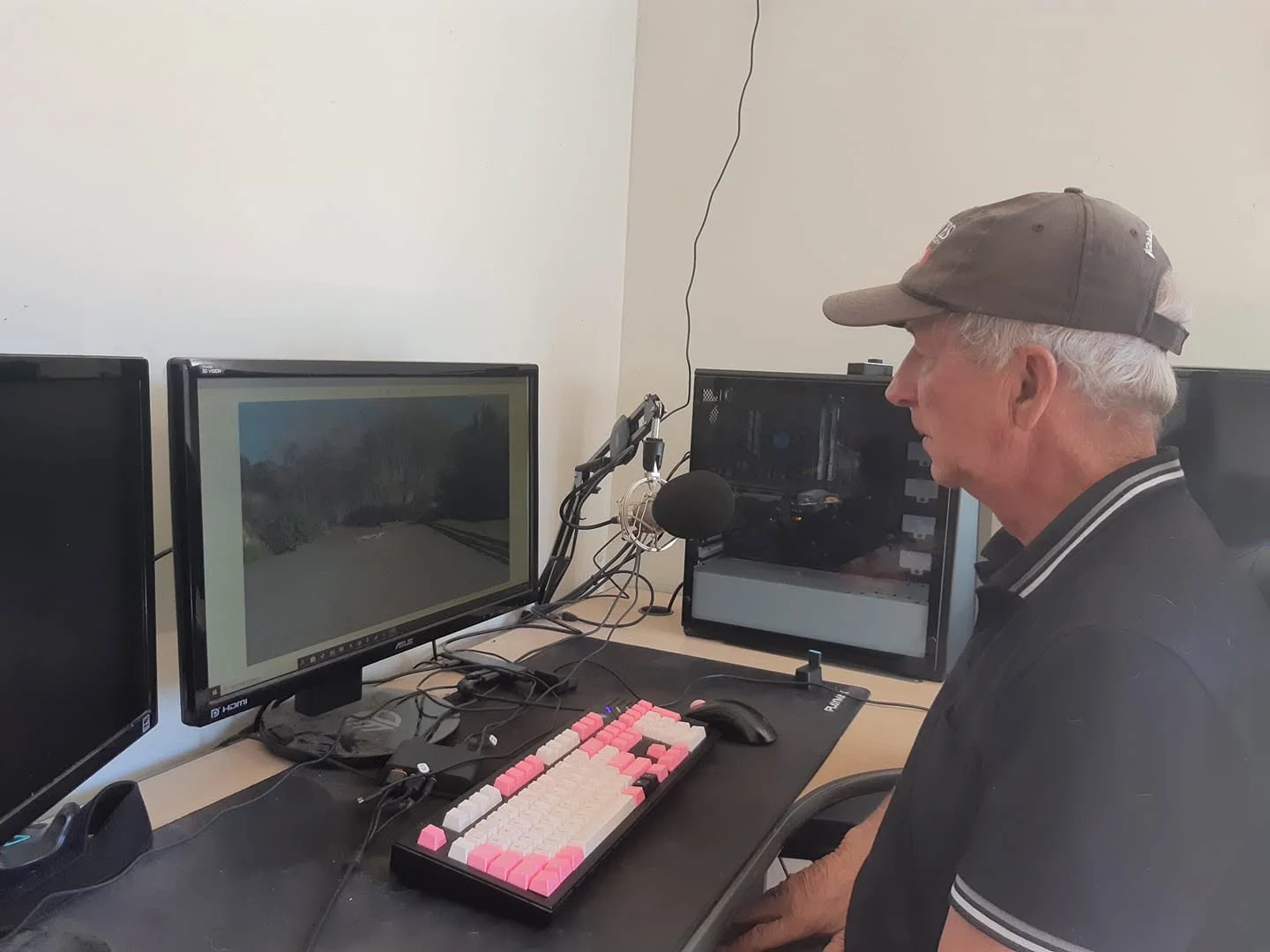Bill Noble at his desk reviewing a test video on screen